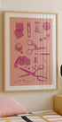 a framed poster of sewing and crafting tools, including scissors, pins, needles, and other sewing-related items, hanging on a wall above a bed.
