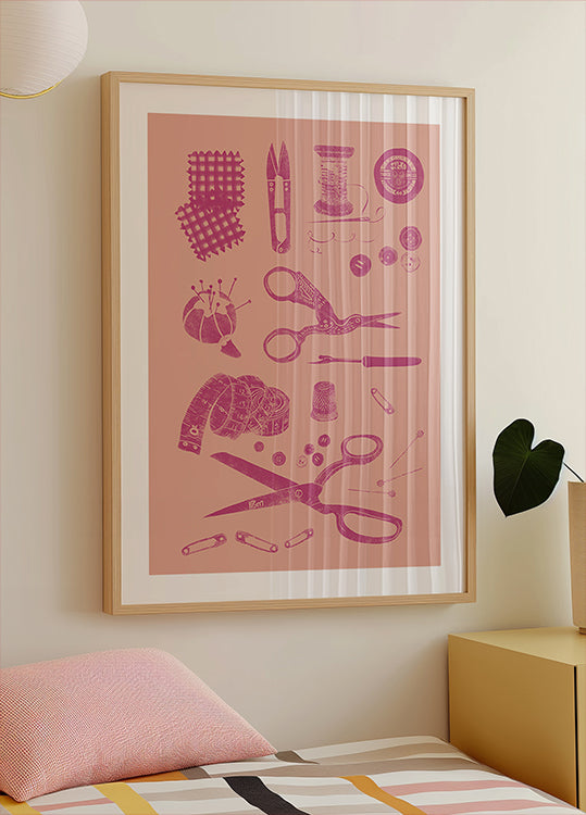 a framed poster of sewing and crafting tools, including scissors, pins, needles, and other sewing-related items, hanging on a wall above a bed.