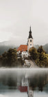 A Church On An Island In The Middle Of Lake Bled Poster - Posterbox.dk