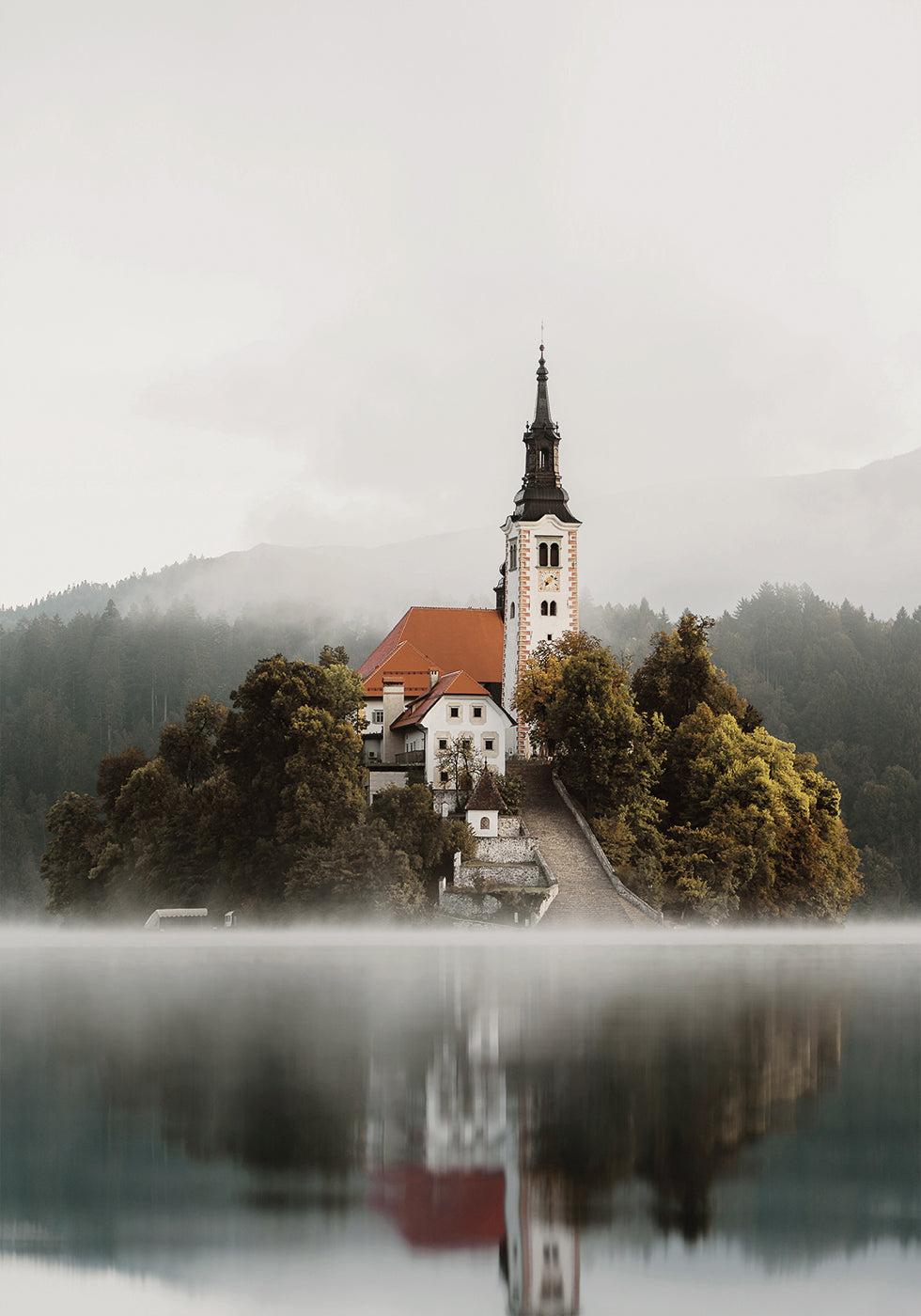 A Church On An Island In The Middle Of Lake Bled Poster - Posterbox.dk