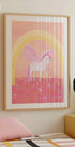 a framed poster of a unicorn with a pink and white color scheme, set against a pink and yellow background with a rainbow arch.