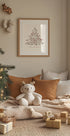 a teddy bear sitting on a pillow in front of a Christmas tree