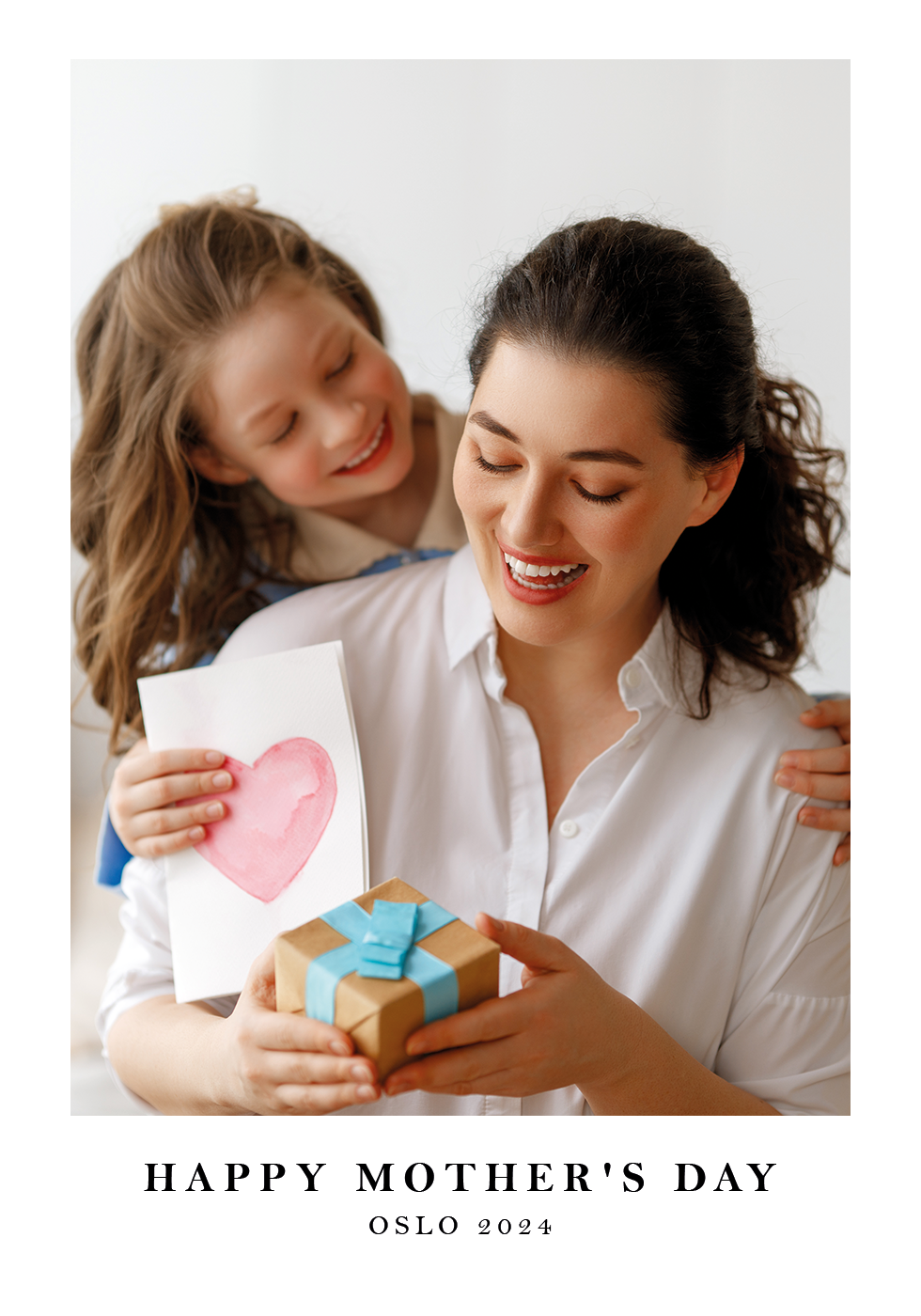 a woman and a girl holding a gift box
