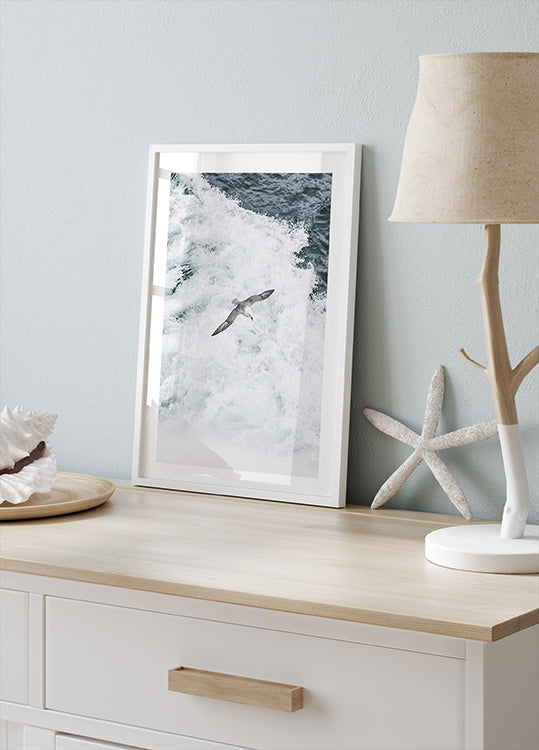 Gray Seagull Flying Over Waves Poster - Posterbox.dk