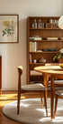 a cozy and well-organized living room with a wooden bookshelf, a round wooden table, and a wooden chair. The room has a warm and inviting atmosphere, with natural light streaming in from the window.