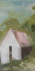 a white house with a pink roof, set against a lush green landscape with trees and foliage.